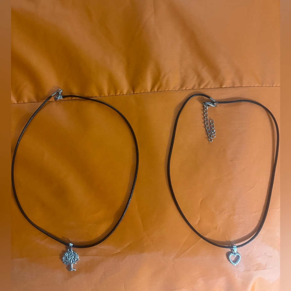 These Ebony Silver Heart & Palm Tree Necklace can be a set of two necklaces.